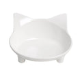 White shallow melamine cat bowl with non-slip rubber base on a wooden floor.