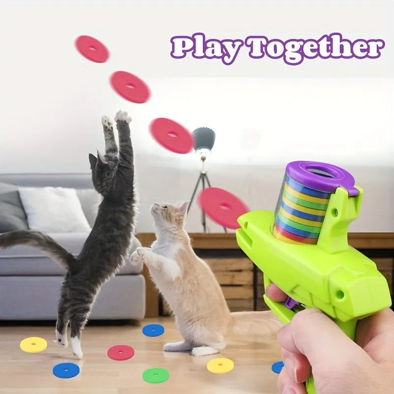 Interactive cat toy launcher with foam discs in green and purple colour options for battery-free feline play