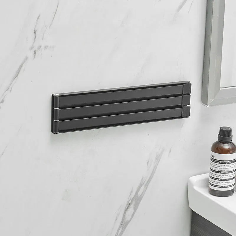Nordic folding carbon steel towel bar in black mounted on bathroom wall