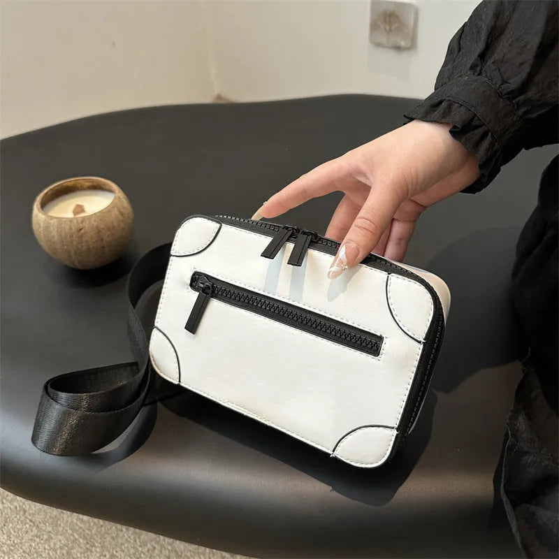 Women's small square PU crossbody bag in black with sewing line detail, single shoulder strap, and external pocket