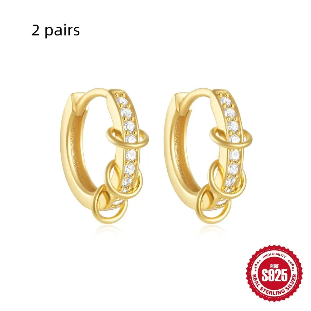 Small round geometric sterling silver stud earrings with an electroplated gold or silver finish.