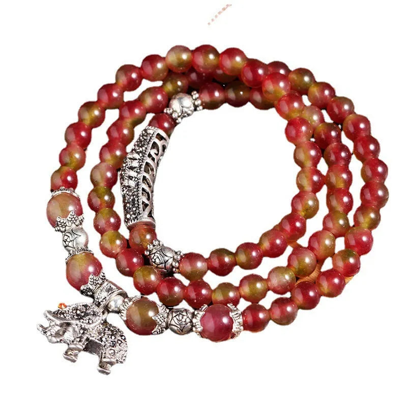 Handmade geometric bracelet made from natural watermelon crystal beads with a traditional Chinese knot clasp.