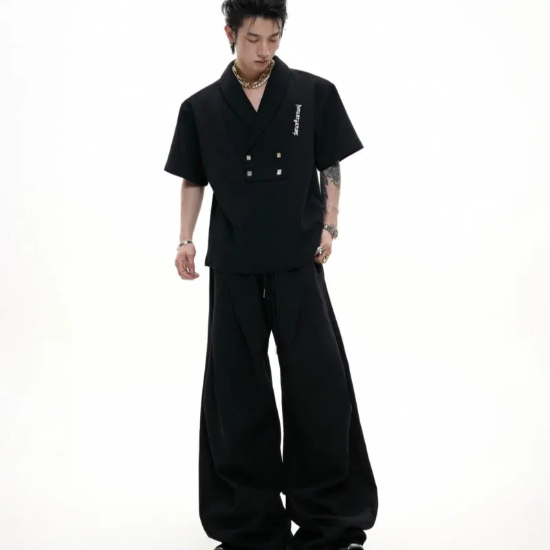 Men's dark grey V-neck padded shoulder short sleeve cotton jacket with metal details and matching trousers.