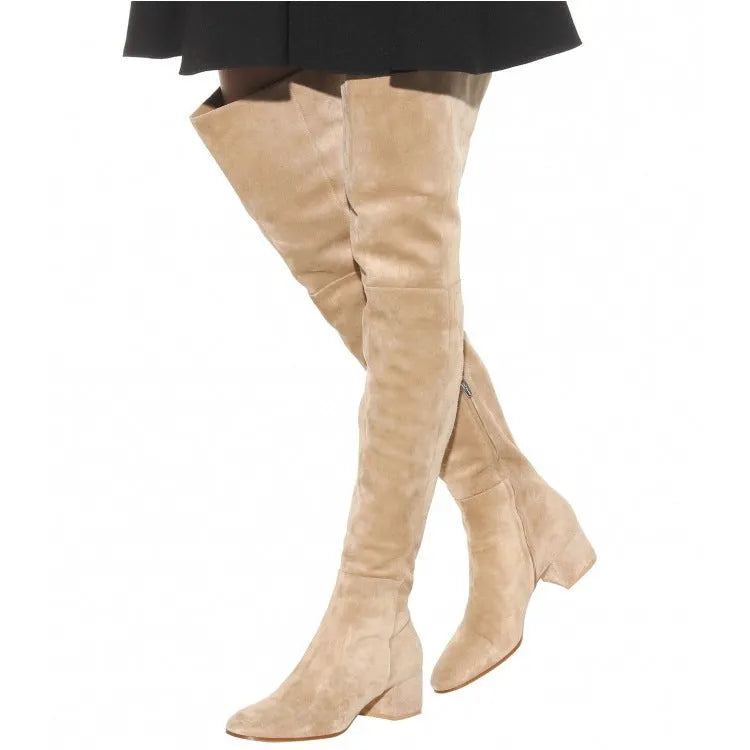 Grey women's suede over-the-knee flat boots with a pointed toe and low thick heel on a white background.