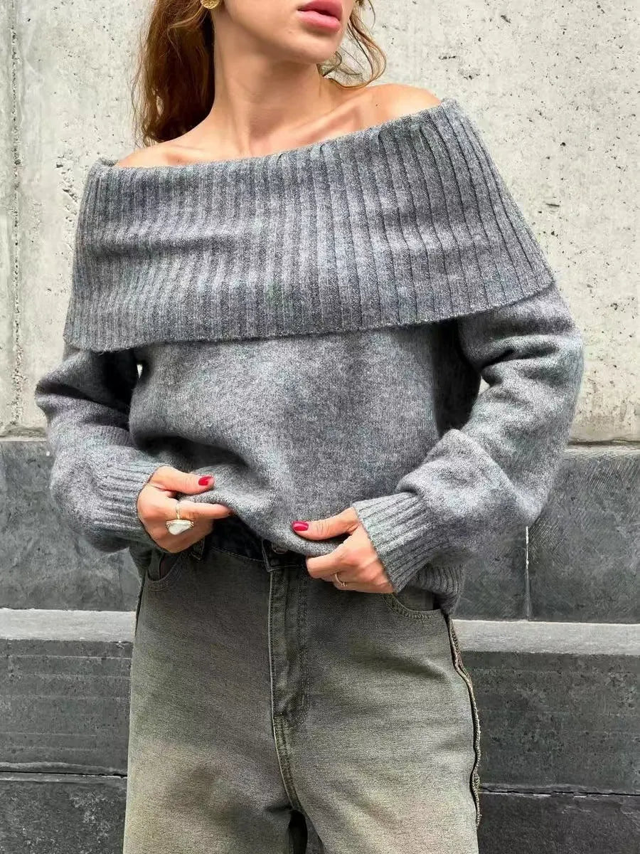 Grey off-the-shoulder acrylic sweater with a 3D pattern texture, modelled from the front.