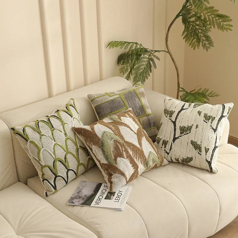 Close-up of a square jacquard pillow cover with a woven retro floral pattern in various colours, sized 45 by 45 cm.