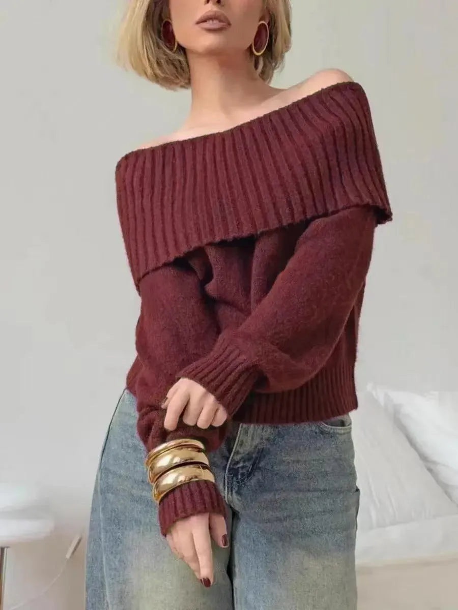 Grey off-the-shoulder acrylic sweater with a 3D pattern texture, modelled from the front.