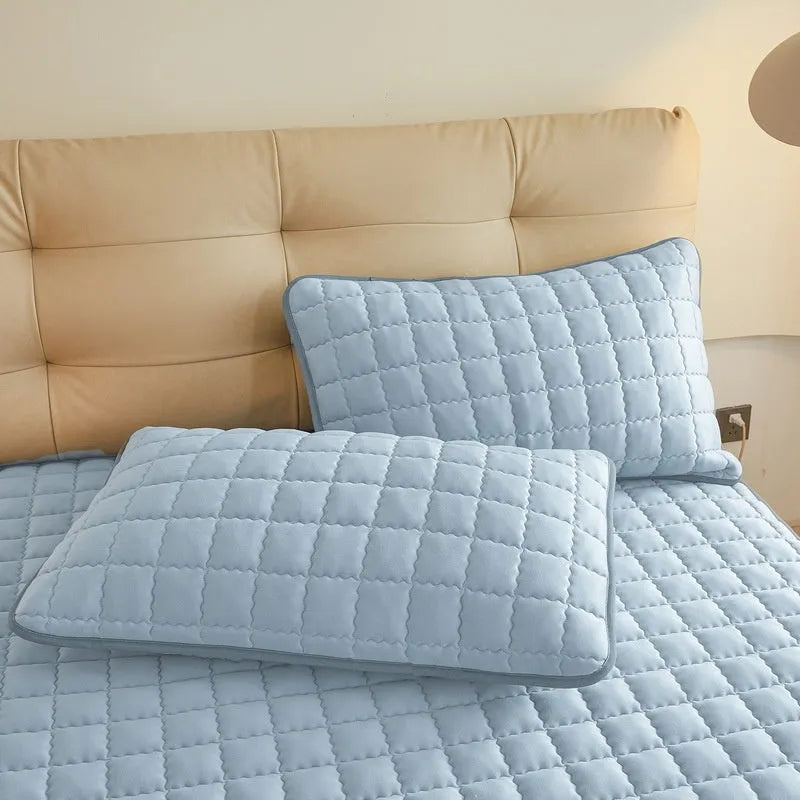 Blue quilted waterproof fitted sheet with elasticated corner on a mattress