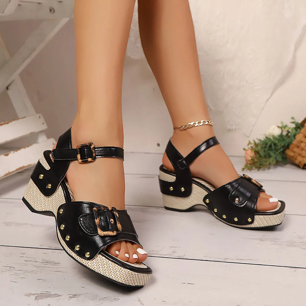 Women's white chunky heel sandals with a square toe and metal buckle closure on a rubber sole.