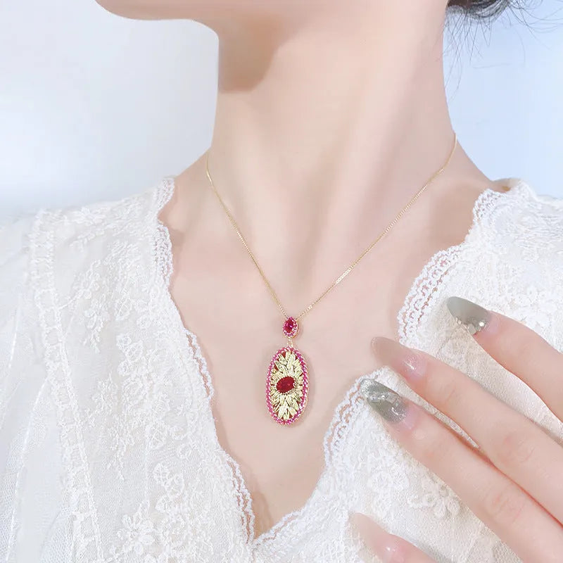 Gold-plated jewellery set with simulated red corundum stones, water drop shape, diamond cut finish, necklace ring ear studs