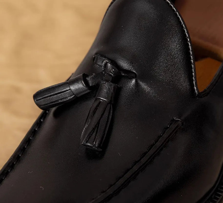 Men's black leather slip-on loafers with fringed detail and rubber sole