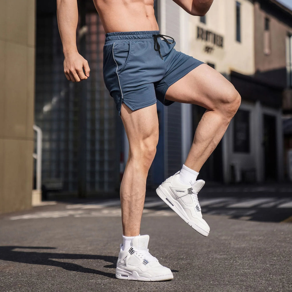 Man wearing straight-leg black polyester sports shorts suitable for fitness or casual wear.