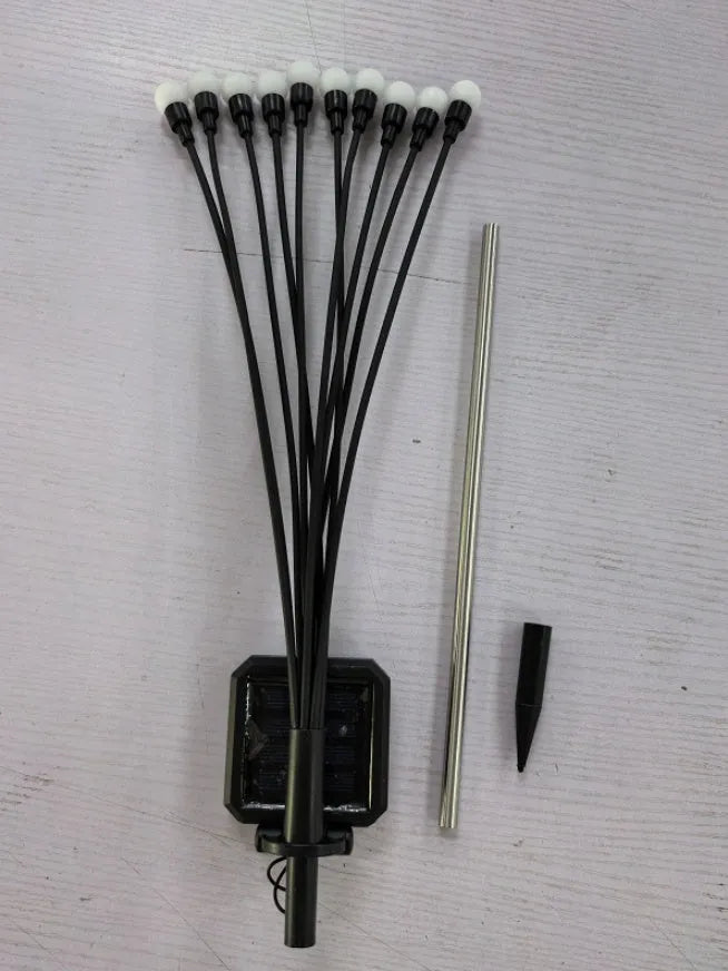 Set of solar-powered LED garden spike lights with multiple heads on stainless steel stakes for lawn or pathway.