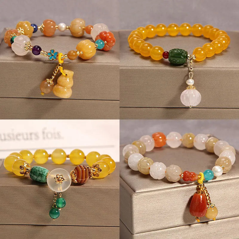 Women's yellow agate crystal bracelet with adjustable gold silk cord on wrist