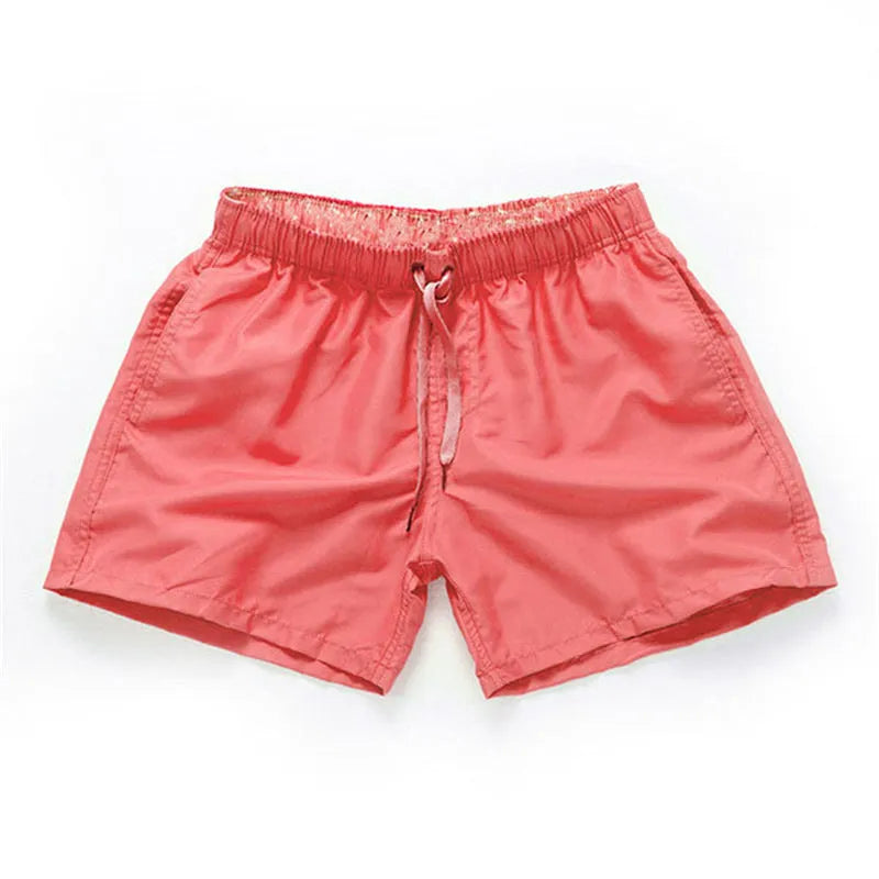 Men's straight-leg beach shorts in black polyester fabric on a size chart.
