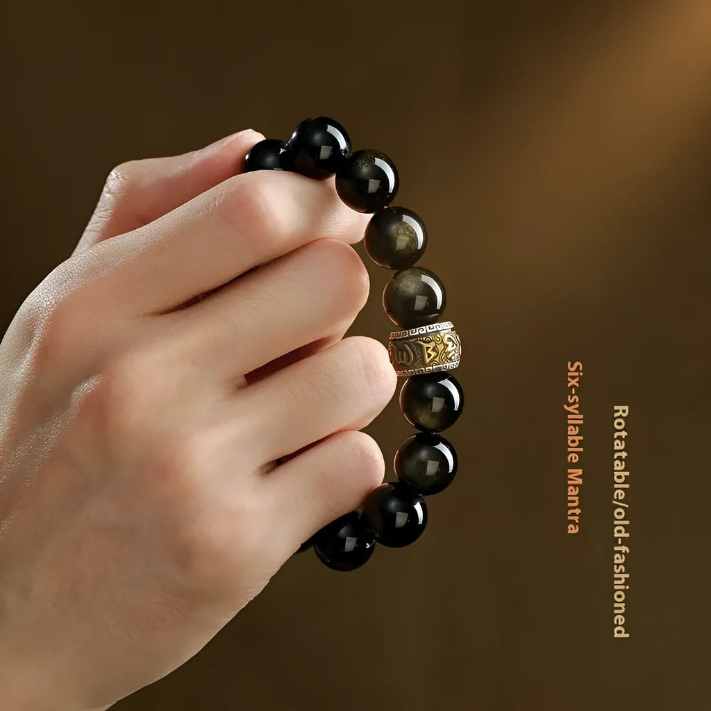 Natural cinnabar bead bracelet with carved animal zodiac design in gold obsidian and silver stone on a silver gift box