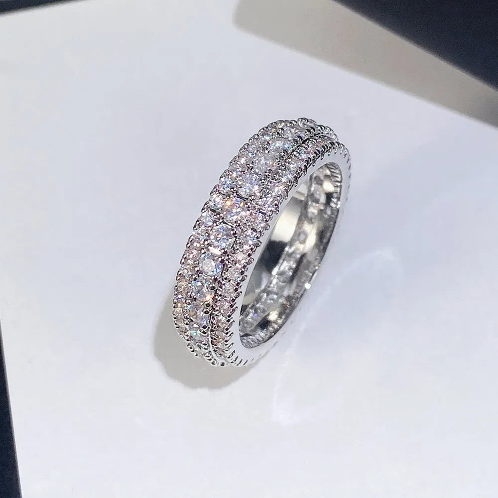 Geometric copper ring with triangular zircon stone and gang drill pattern on band.