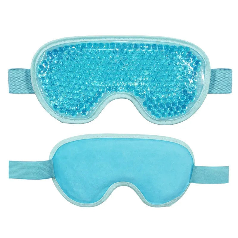 White rechargeable portable eye compress device with a fabric eye mask on a grey background.