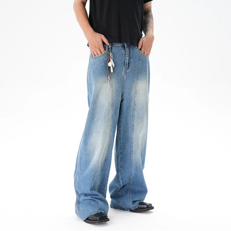 Cut washed vintage washed wide leg machete jeans in light blue denim with zipper fly, front view