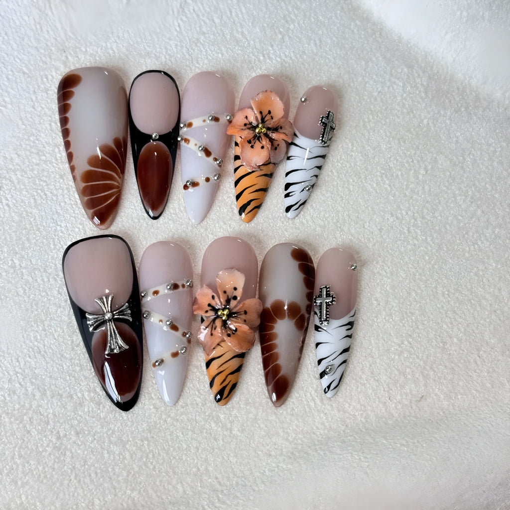 Leopard print false nails with cross and flower designs, shown in long wear armour style