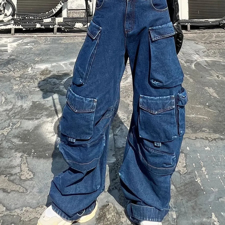 Dark blue distressed women's jeans with wide legs, high waist, and multiple pockets on a neutral background.
