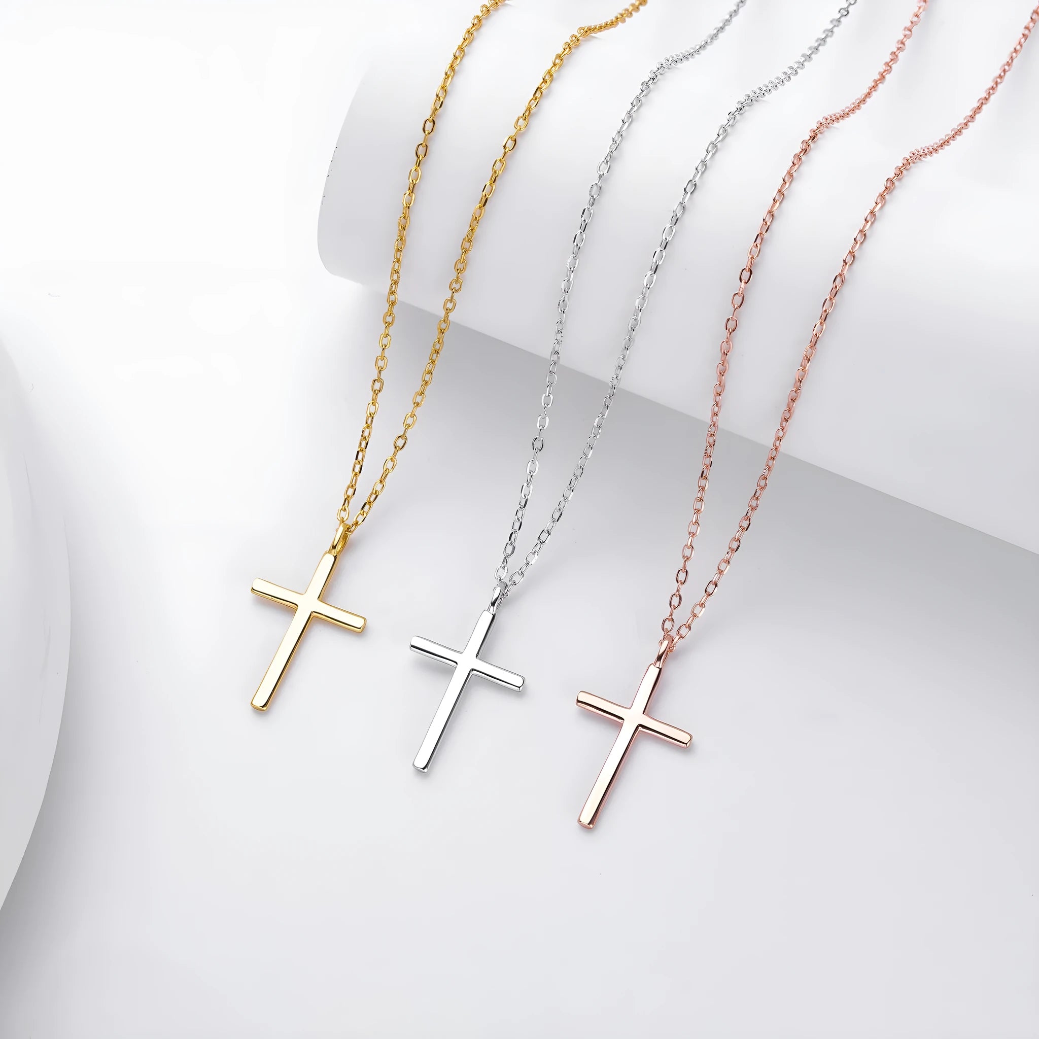 Simple glossy cross pendant on an O-chain sterling silver necklace in gold plating.