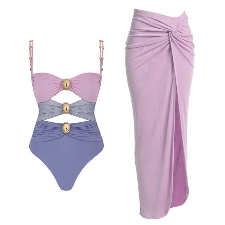 Women's solid colour one-piece swimsuit with gold button and matching skirt in black, blue, brown, or pink.