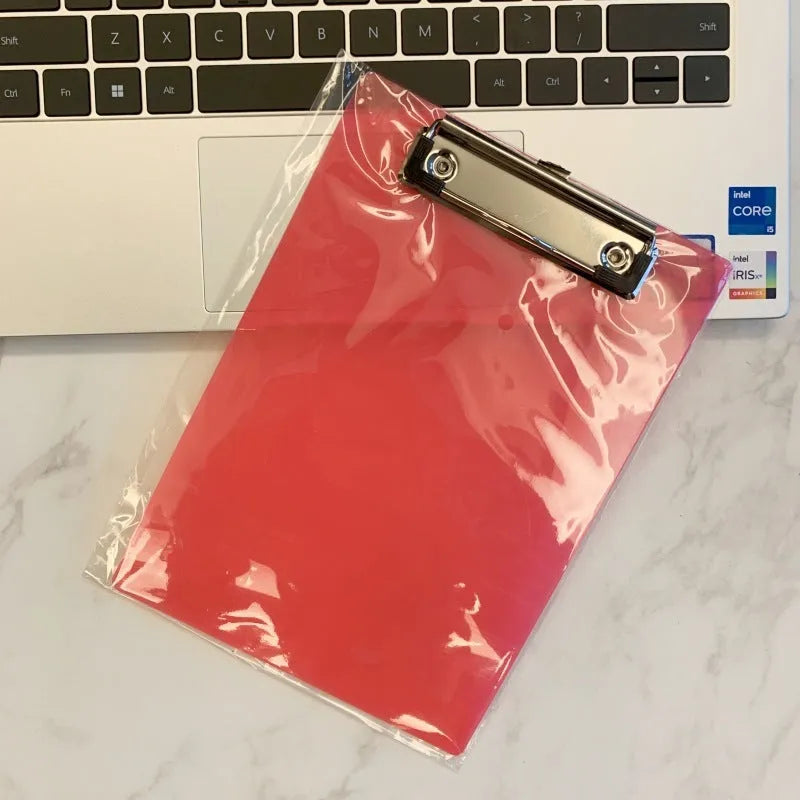 Transparent plastic A4 plate holder with metal clip and integrated writing board surface, shown in blue.