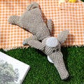 Green, grey, and yellow plush dog chew toy with textured surface and animal shape.