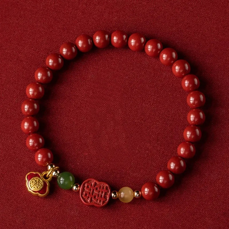 Happy eyebrow bracelet with emperor sandstone beads and a central carved fu charm on a string.