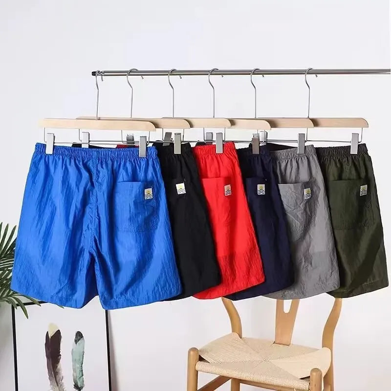 Men's quick-drying polyester sports shorts in 236 blue, straight-leg cut, side view
