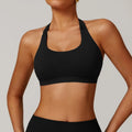 Women's halter style sports bra in black with medium support and built-in chest pads