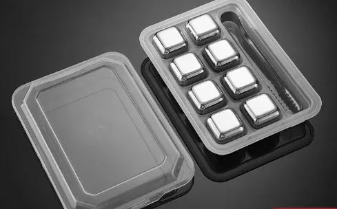 Set of 8 stainless steel ice cubes in square and ball shapes with plastic storage box and tong on a wooden surface