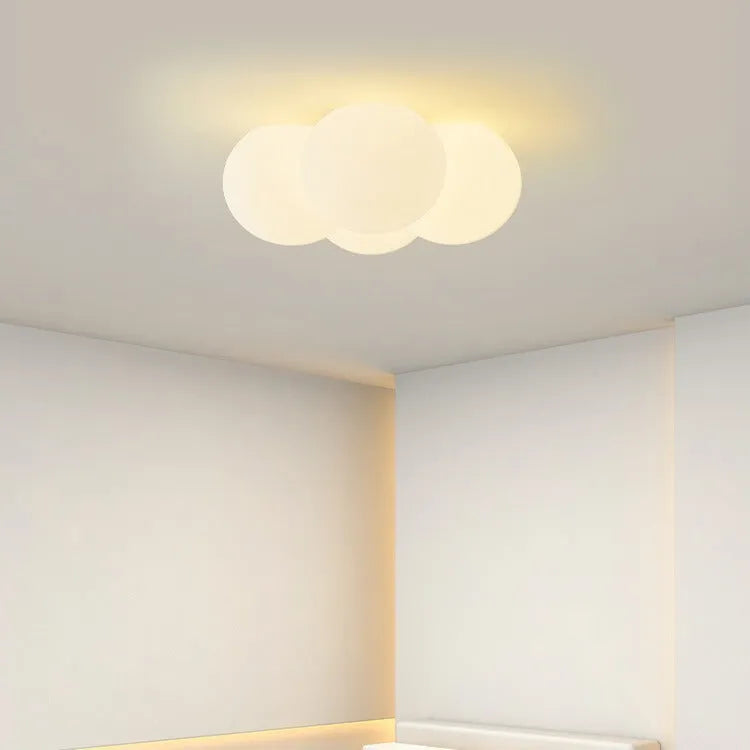 Modern minimalist cloud chandelier with tricolor light, 42mm diameter, ceiling mounted in a bedroom