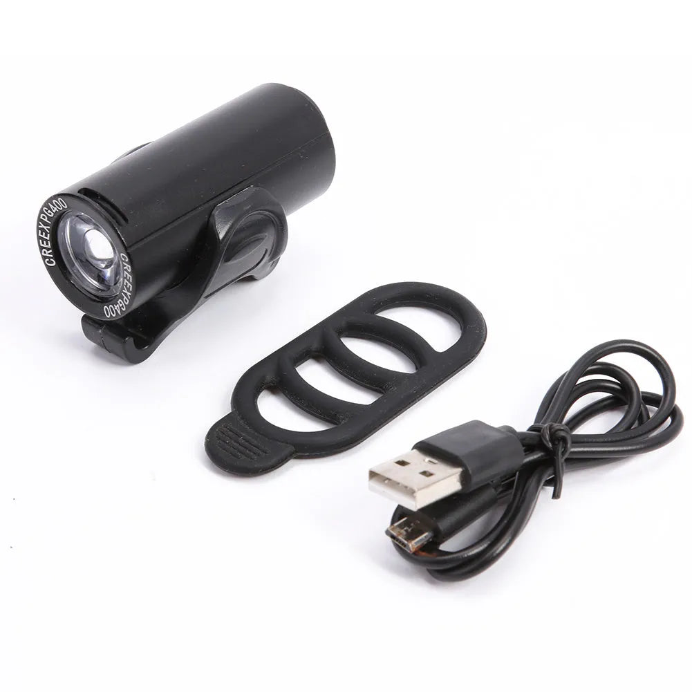 Black rechargeable 350 lumen USB bicycle front light mounted on handlebars for night cycling