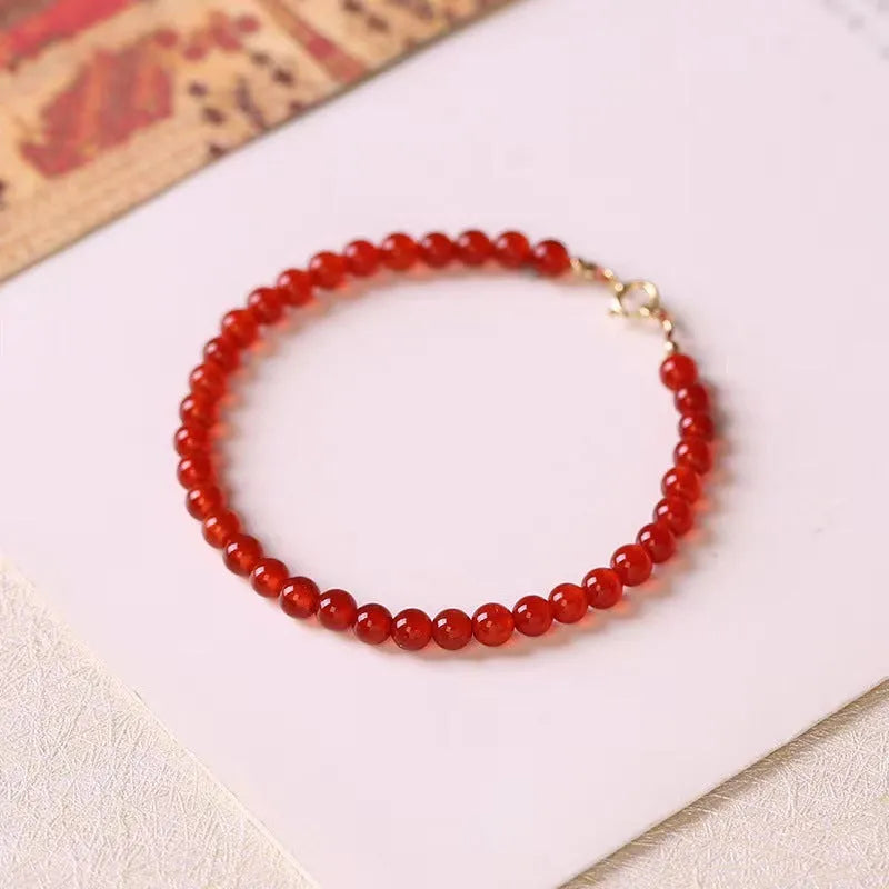 Ultra-thin red agate calm small bracelet for women classic style on neutral background
