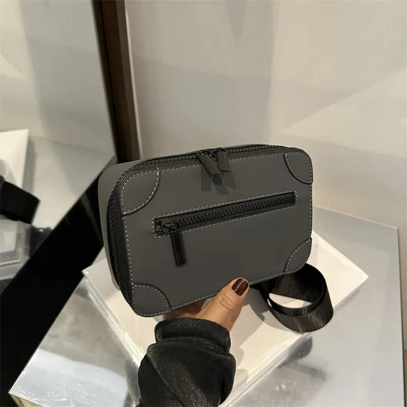 Women's small square PU crossbody bag in black with sewing line detail, single shoulder strap, and external pocket