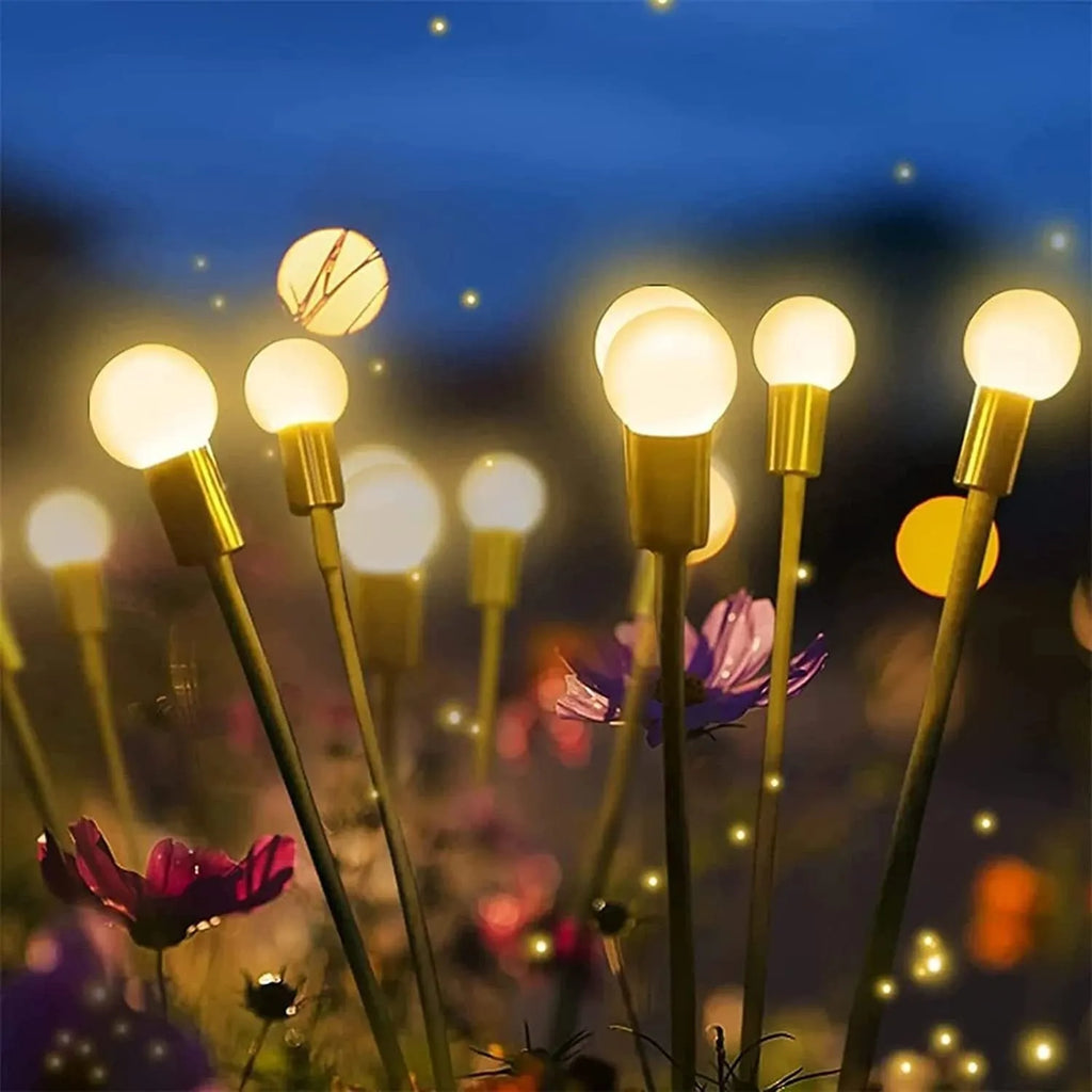 Set of solar-powered LED garden spike lights with multiple heads on stainless steel stakes for lawn or pathway.