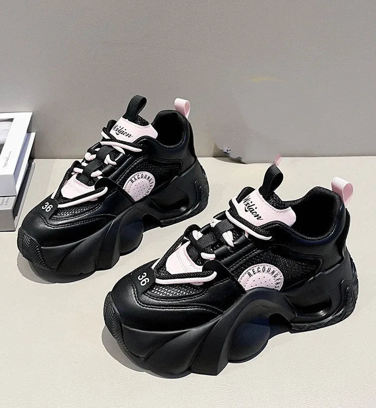Women's pink sneakers with cross shoulder straps, thick platform sole, and breathable mesh lining.