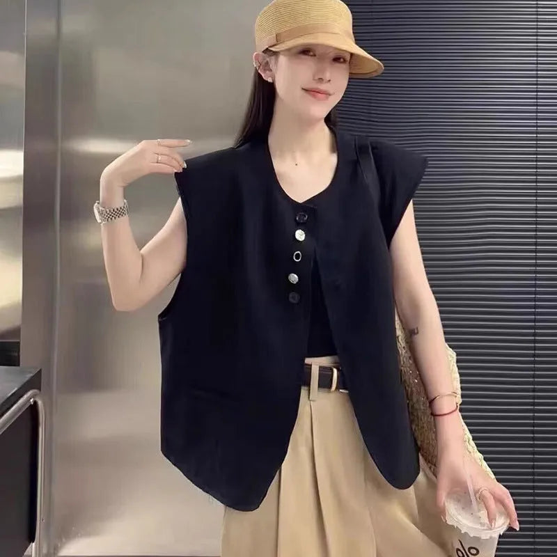 Women's loose fit polyester vest in milky white colour with pockets.