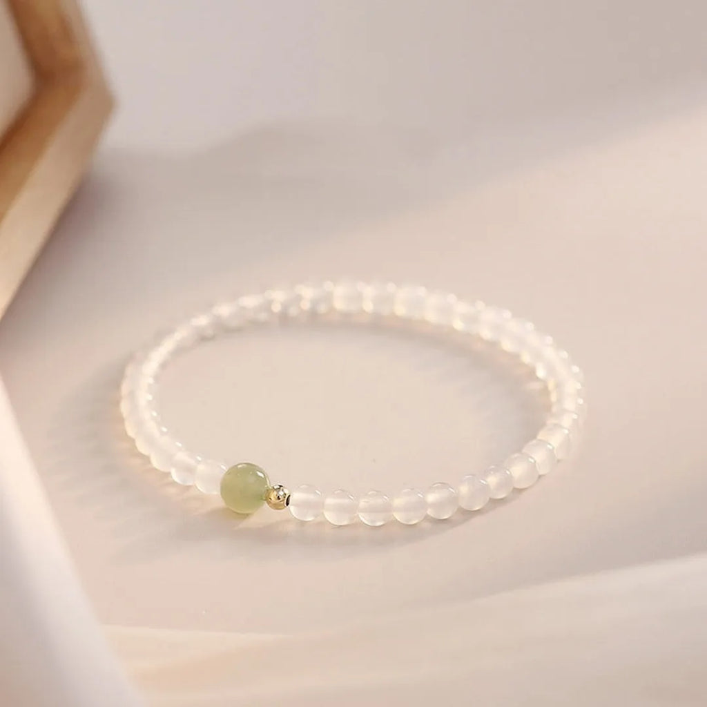 Natural Hetian Jade white agate women's bracelet 15cm on display showing banded white stones
