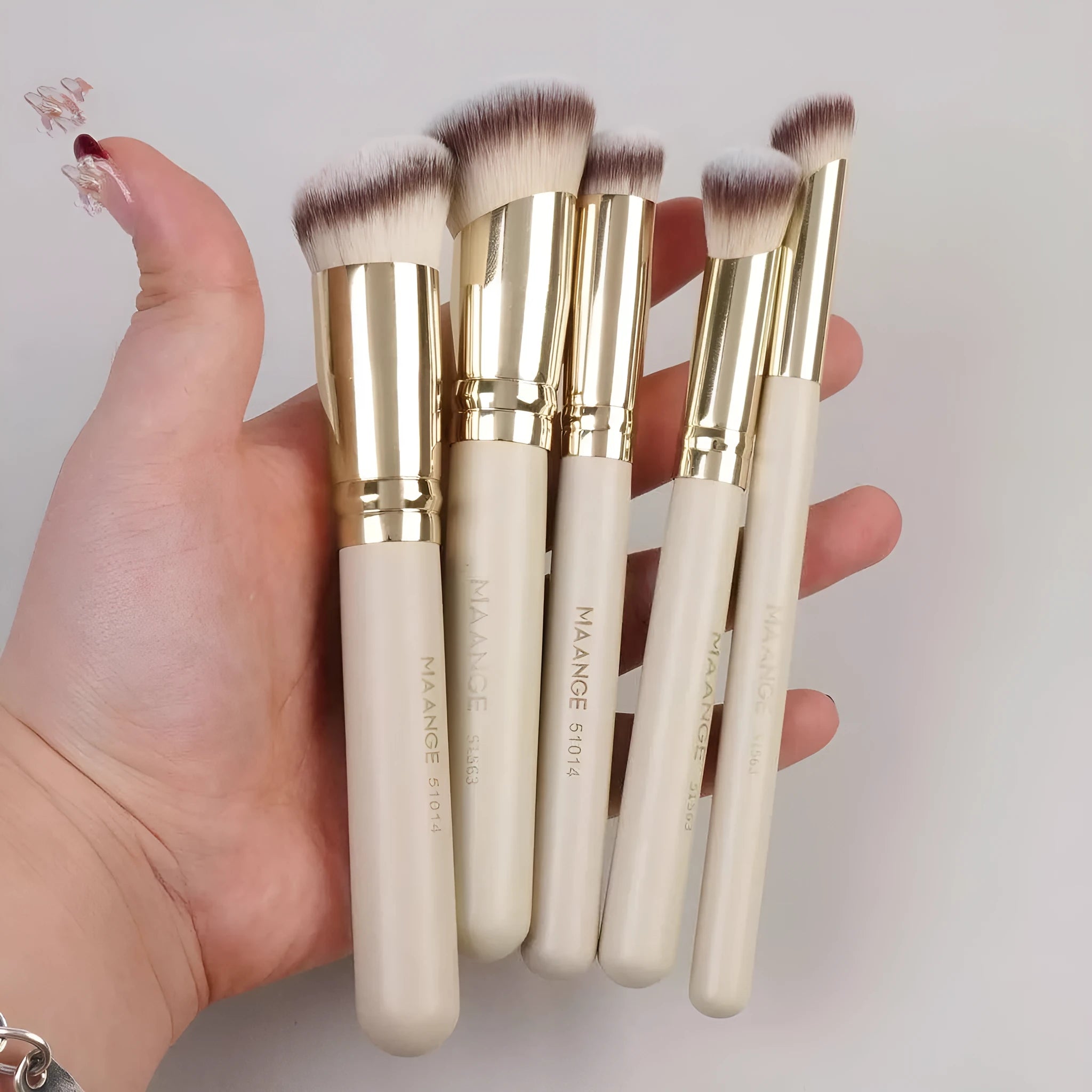 MAANGE set of five apricot-coloured makeup brushes with angled blusher brush on a white background.