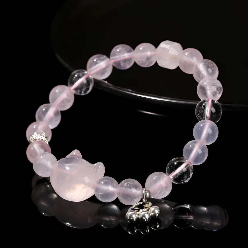 Natural star pink crystal cat head bracelet on a woman's wrist