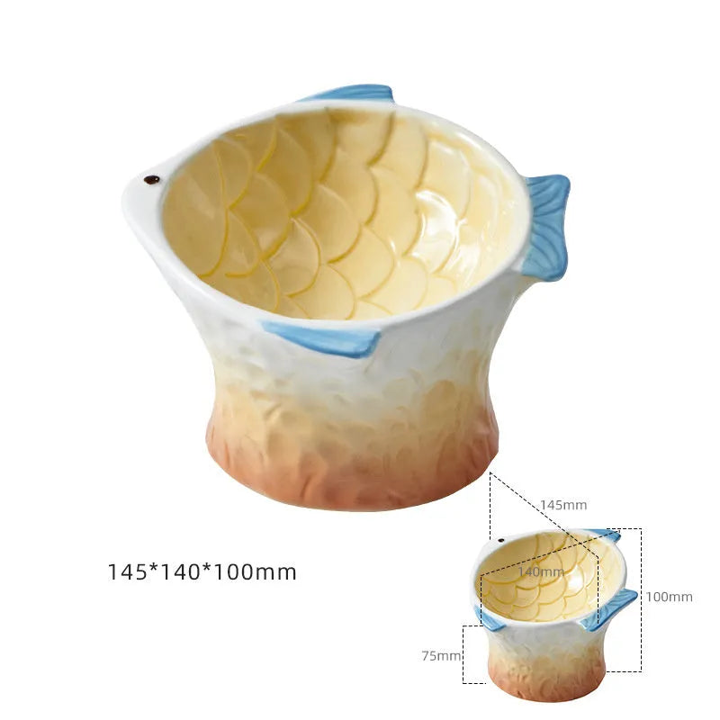 Blue ceramic fish-shaped cat feeder bowl with a tilted, elevated design on a non-slip base.