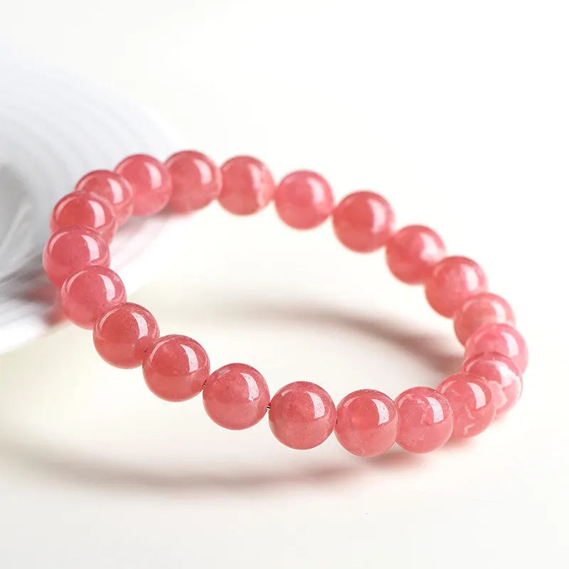 Women's red rhodochrosite crystal bracelet with geometric beads and a longevity lock clasp.