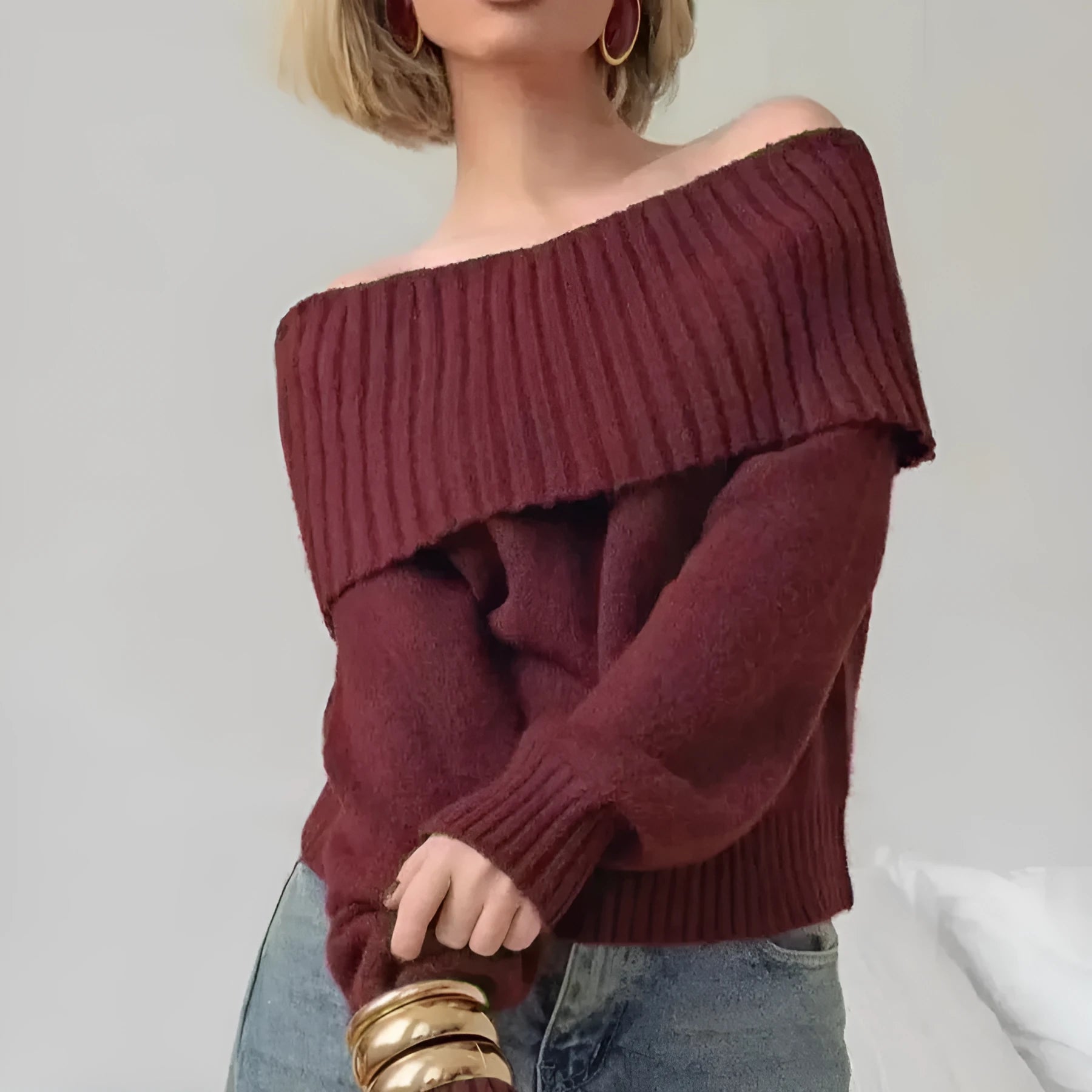 Grey off-the-shoulder acrylic sweater with a 3D pattern texture, modelled from the front.