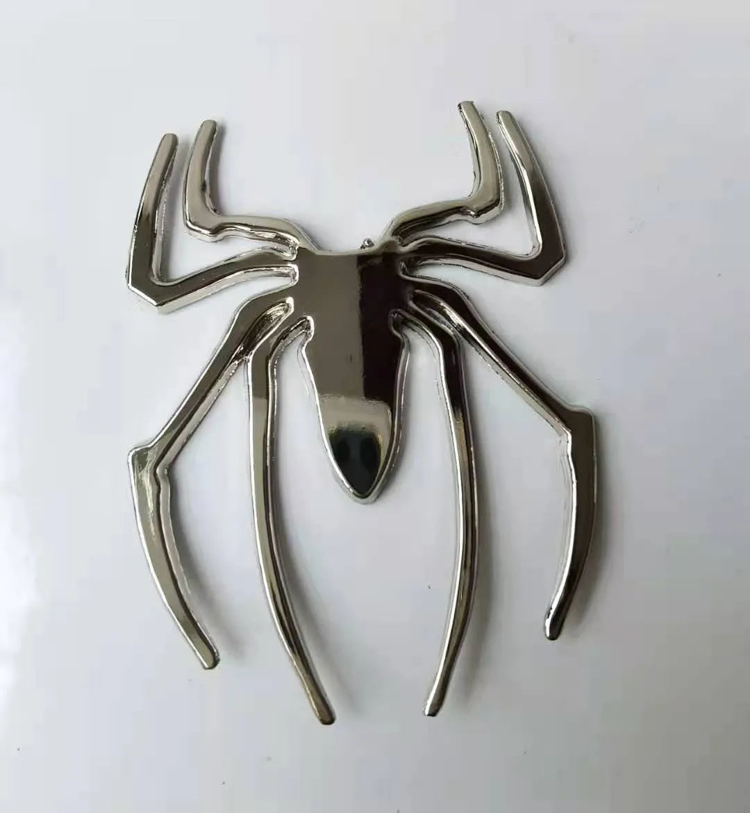 3D metal spider car bumper sticker in gold, silver, black, or red on a white background
