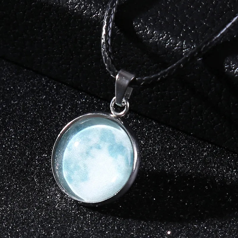 Luminous alloy pendant necklace with Christmas moon, night sky, and constellation design on a glass centrepiece.