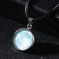 Luminous alloy pendant necklace with Christmas moon, night sky, and constellation design on a glass centrepiece.