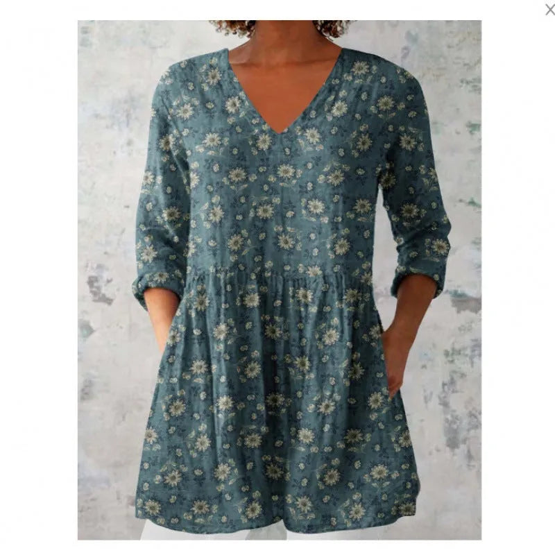 Women's printed loose dress with wide waist and 3/4 length sleeves on a hanger.
